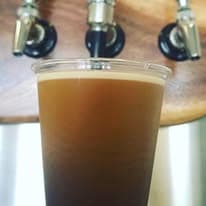 Hoku nitro cold brew pouring into a cup beneath the taps